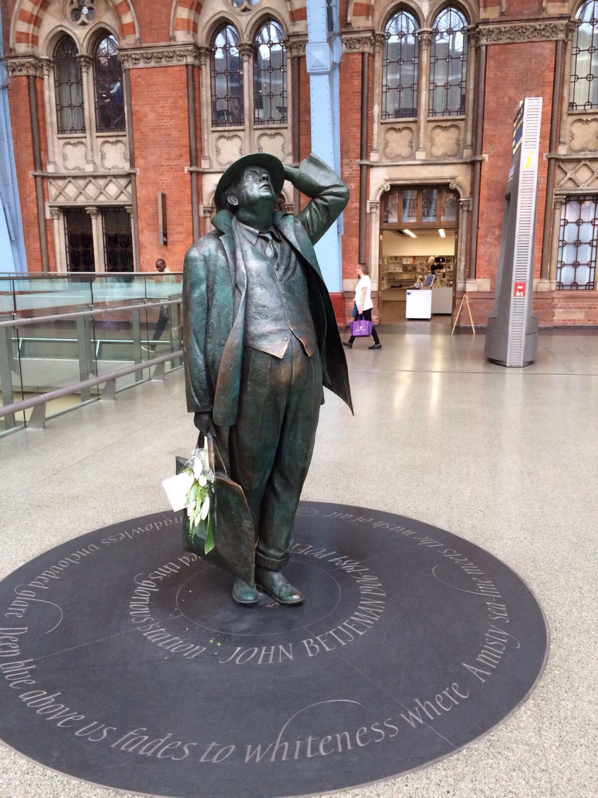 Sir John Betjeman  and an embracing couple  can't be missed at the iconic 'meeting place' in St. Pancras Station